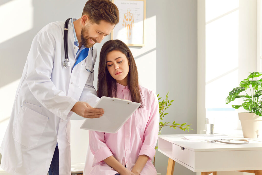 A man and a woman are looking at a tablet together.