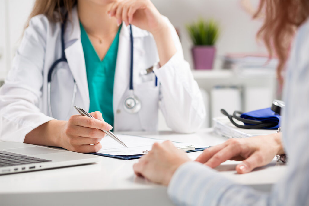 The image depicts a doctor and a patient engaged in a discussion, likely about health-related concerns or treatments.